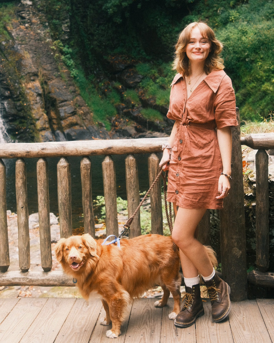 artist abi toads smiling in the woods with her dog