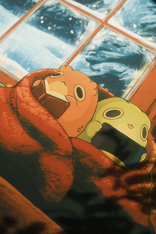 closeup of print of two frogs snuggled up in a blanket by a frosted window