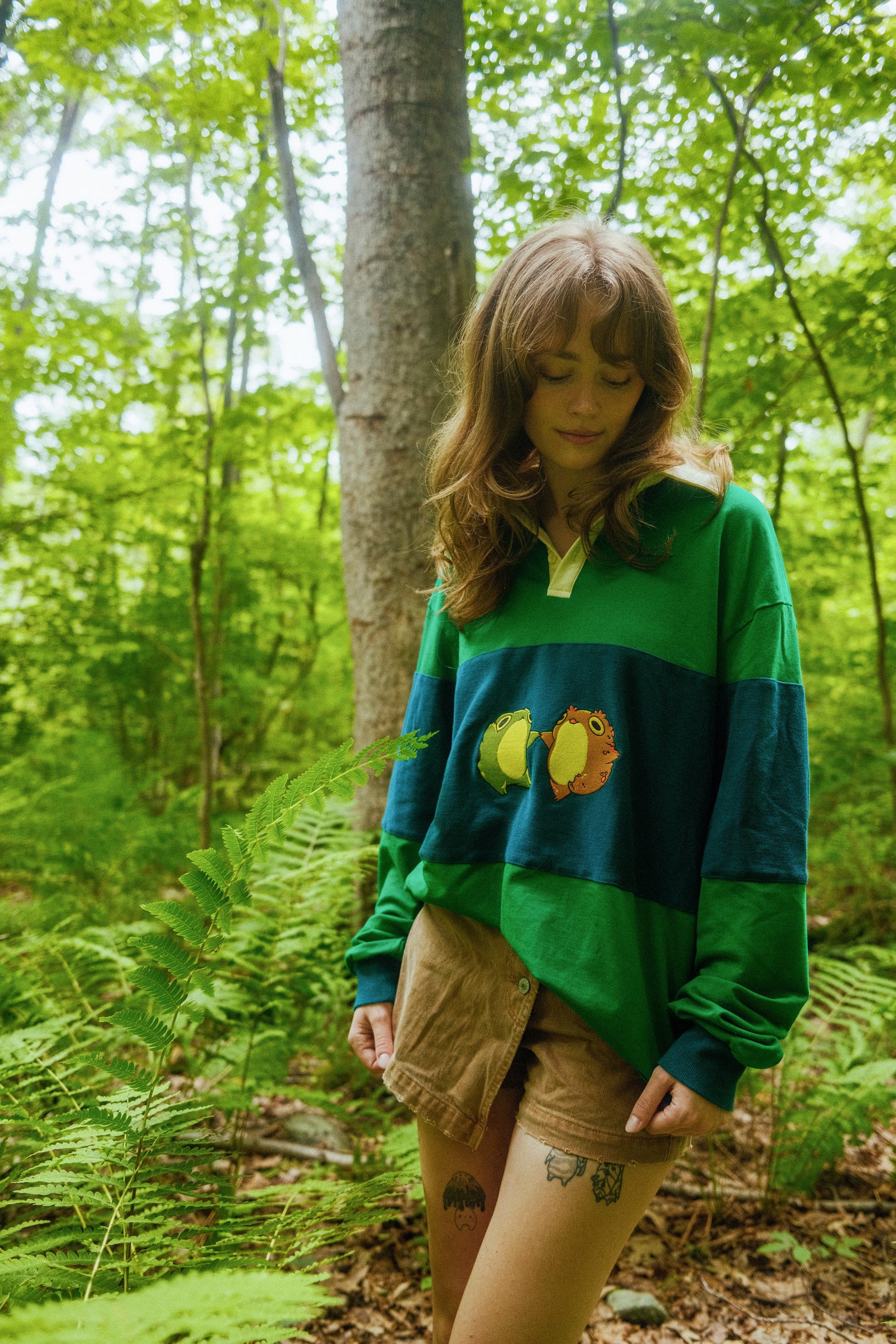 abi toads wearing blue and green rugby shirt in the woods