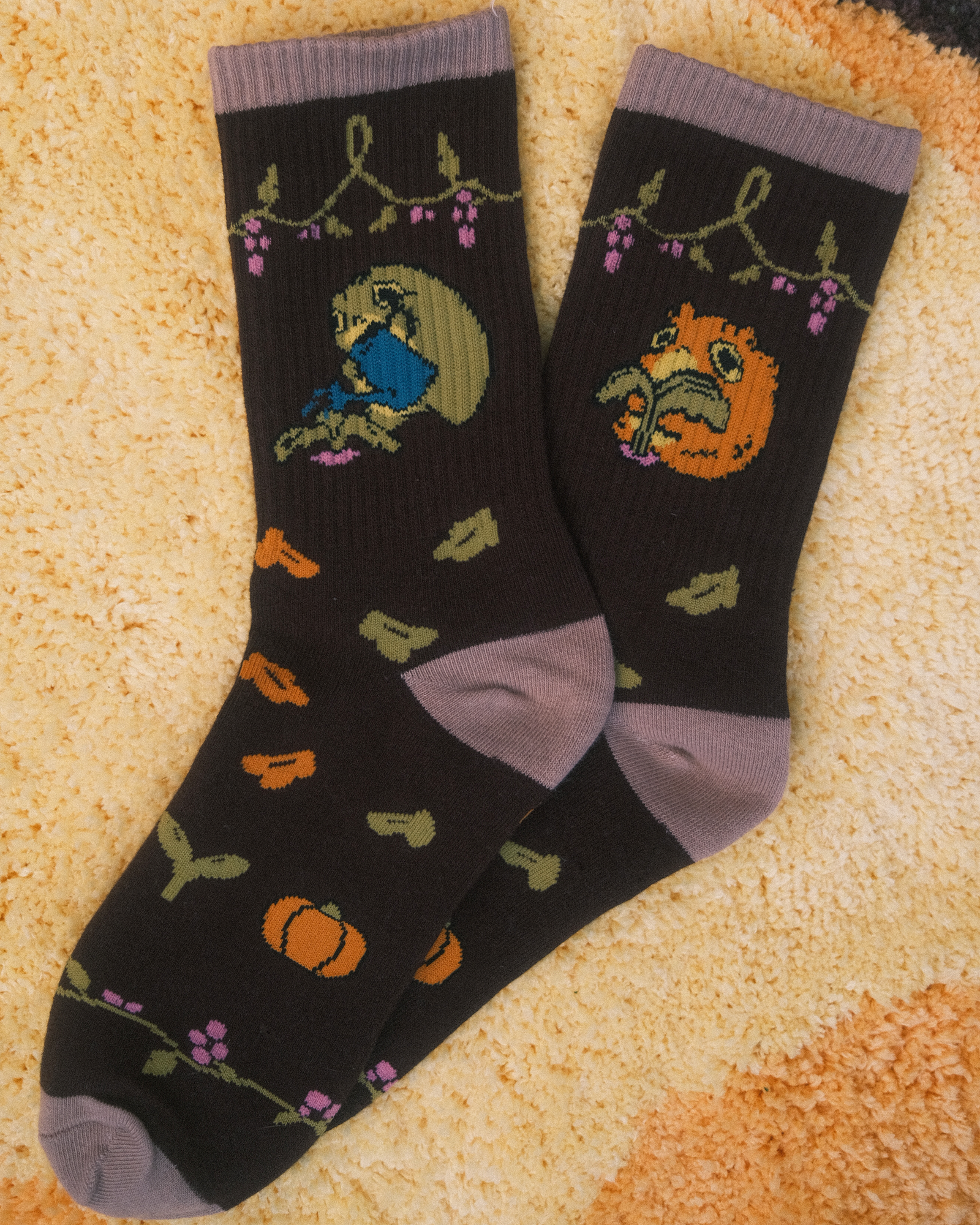 pair of brown socks depicting two frogs gardening