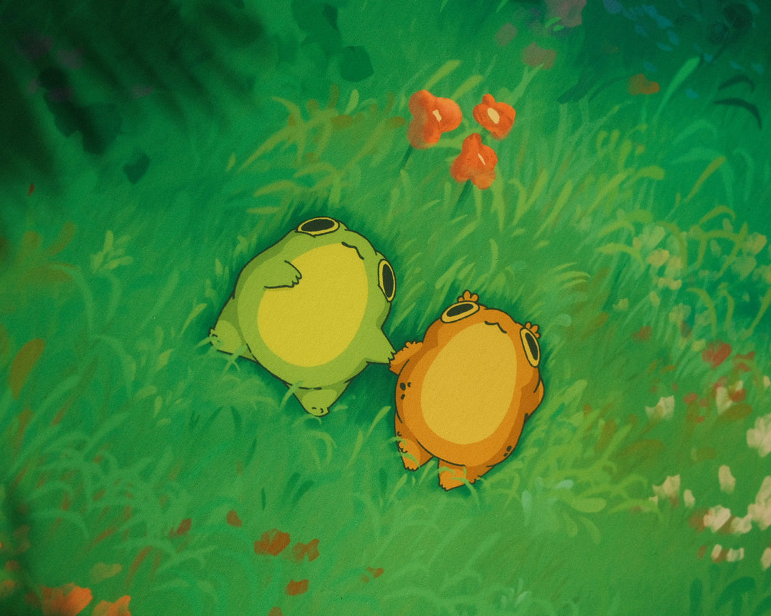 Two animated frogs sitting on a grassy field with flowers.