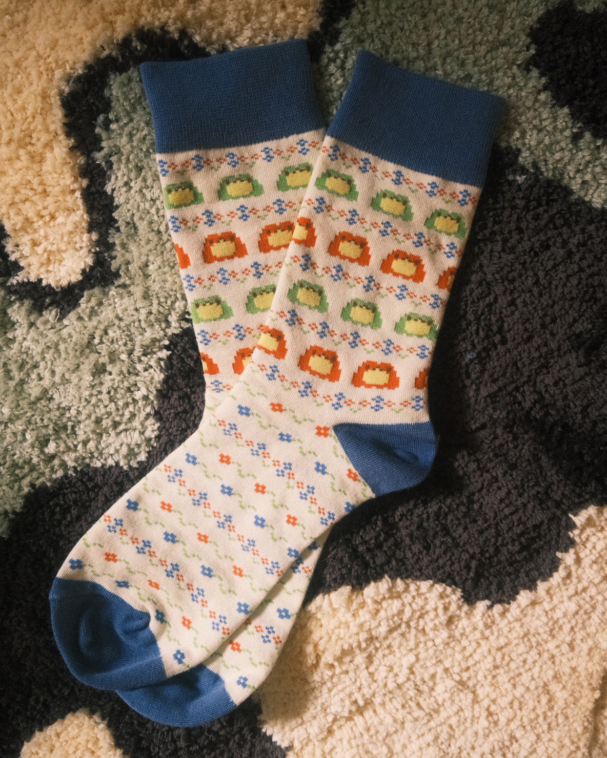 white socks with fair isle frog pattern on them