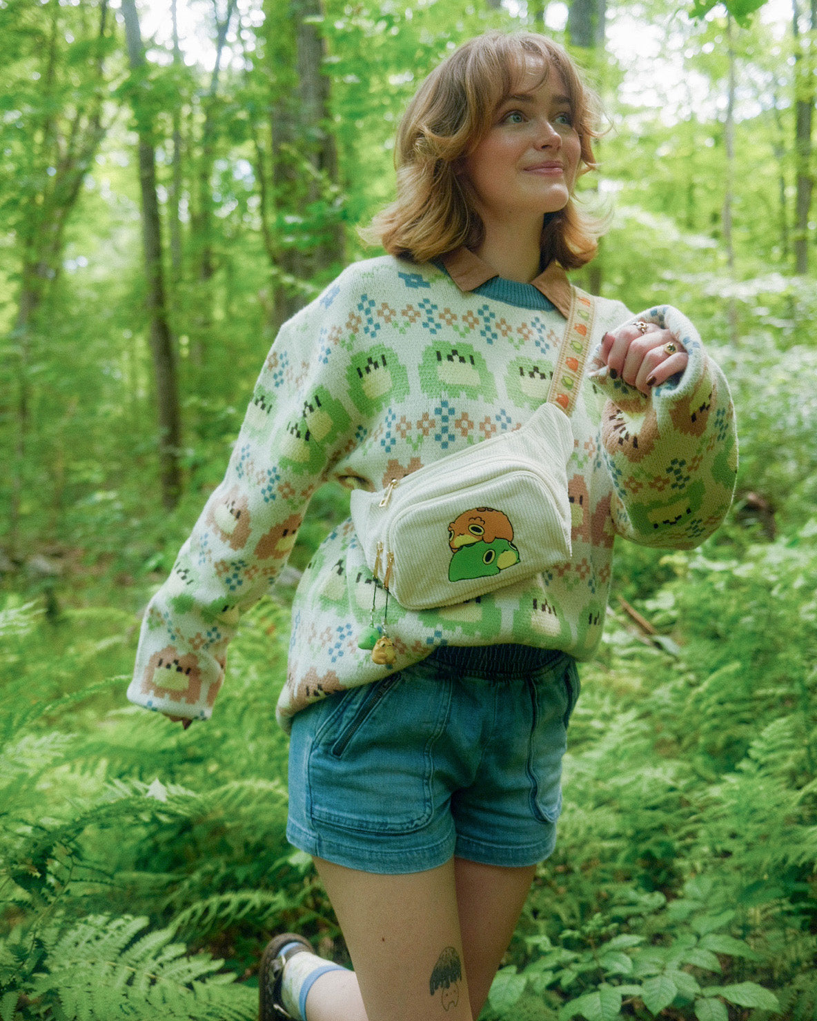 abi toads wearing a sweater with frogs in a fair isle pattern across it