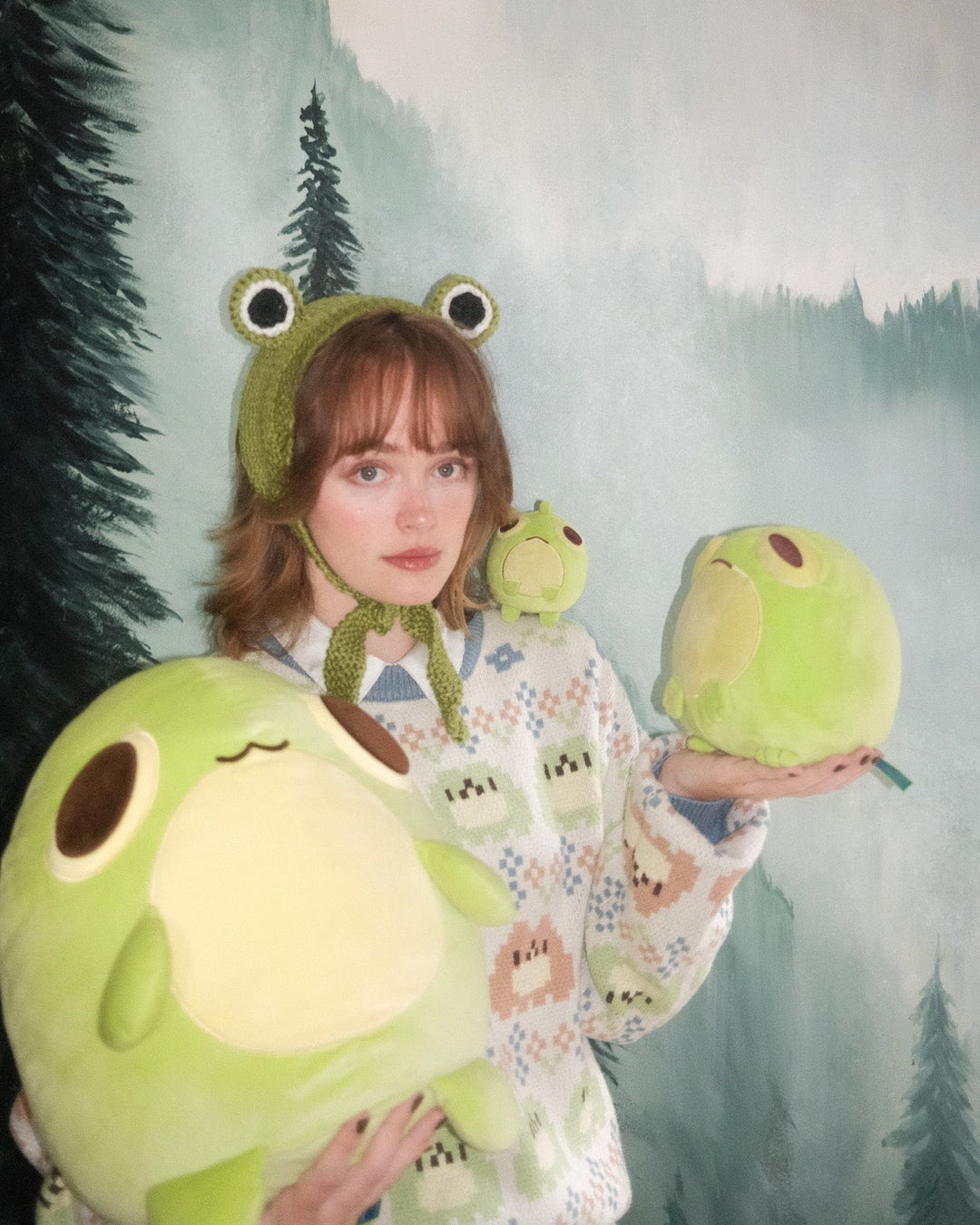 artist abi toads holding three frog plushies