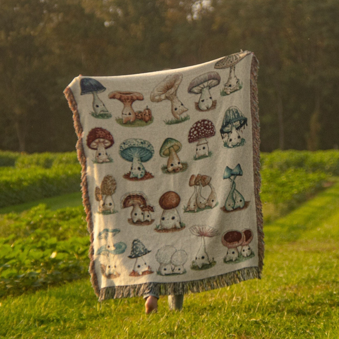 woven blanket depicting mushlings in a field