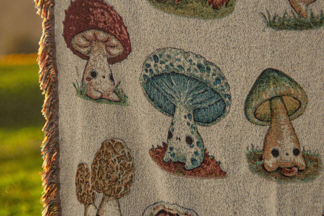 woven throw blanket depicting mushroom characters closeup