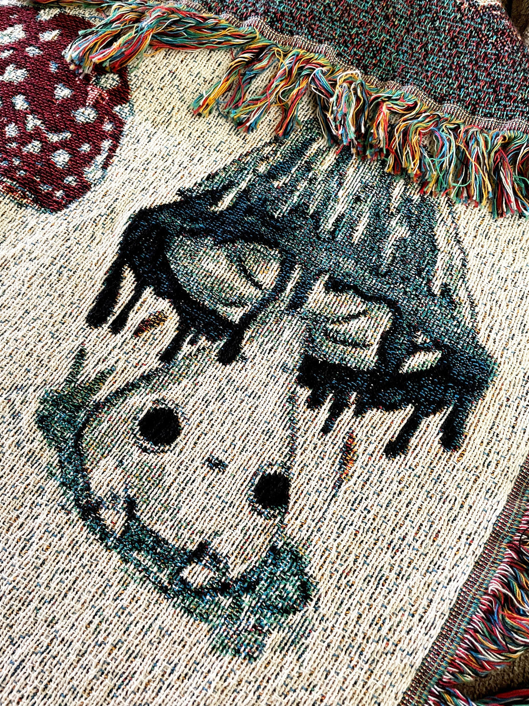 woven throw blanket depicting mushroom characters closeup showing inky cap mushling