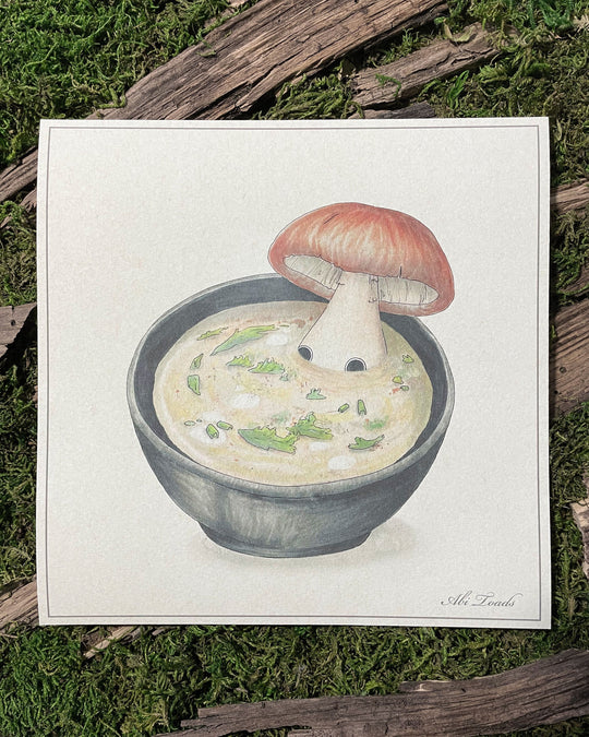 print of mushroom character laying in soup