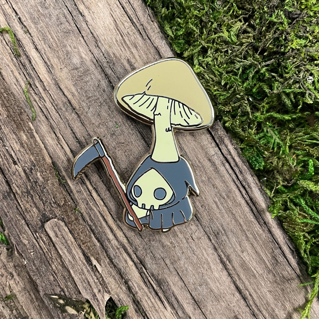 pin of death cap mushling dressed up as grim reaper