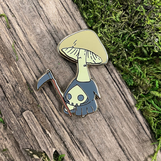 pin of death cap mushling dressed up as grim reaper