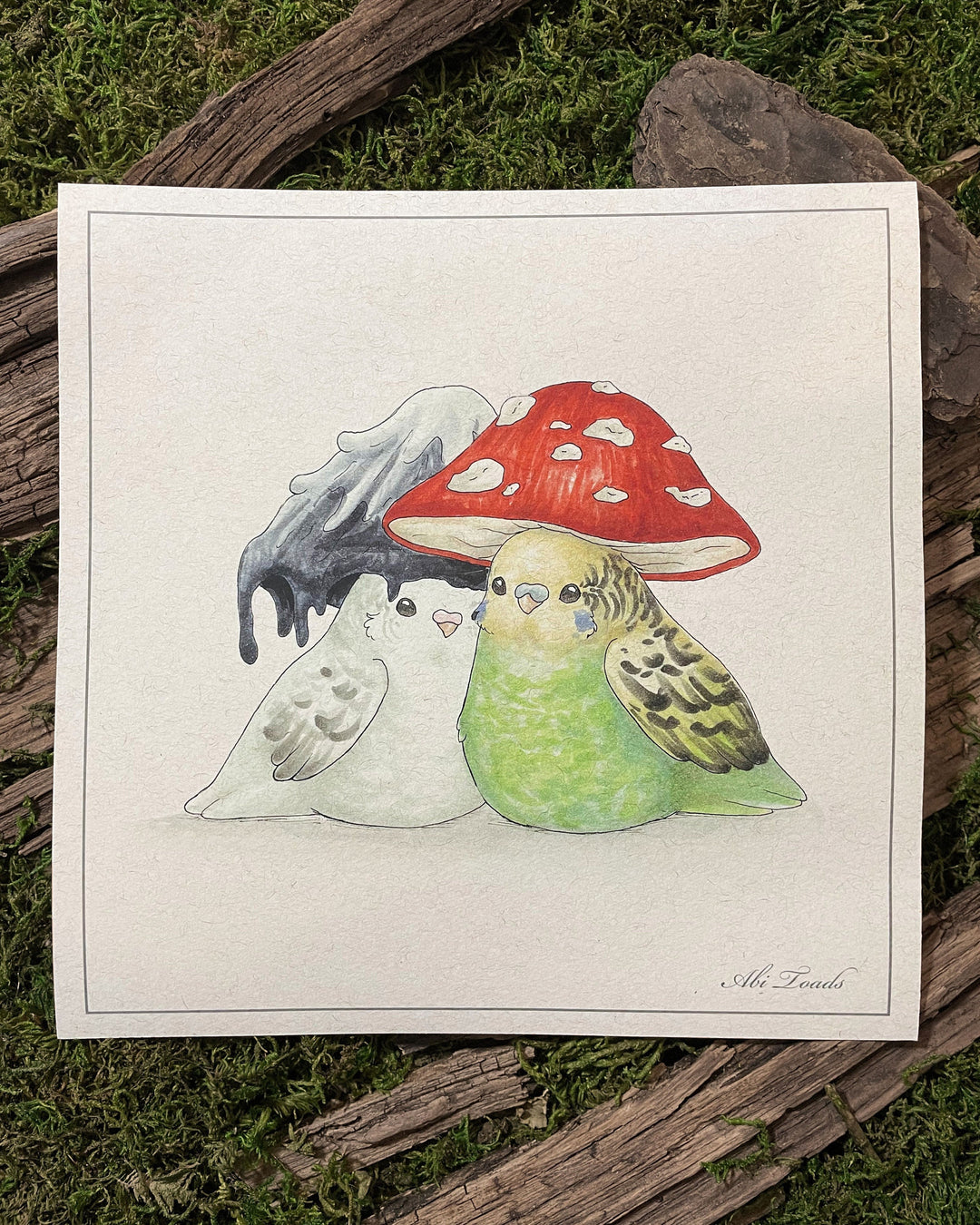 A print of two lovebirds with mushroom-shaped hats on their heads