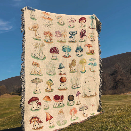 A queen-sized blanket with a woven design featuring various colorful mushroom characters