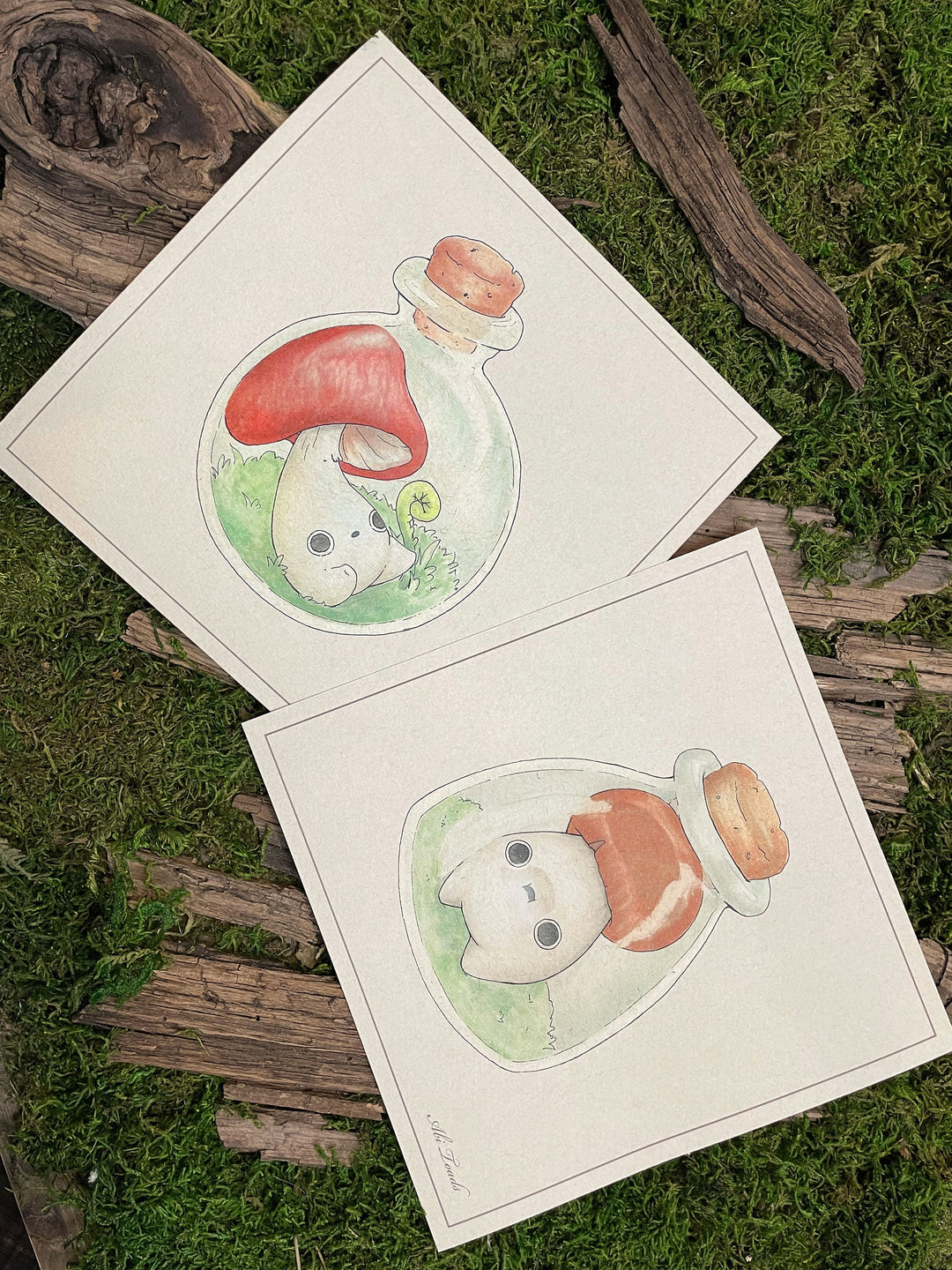 pair of prints depicting mushlings trapped in jars 