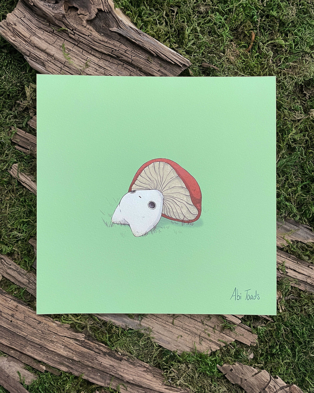 print of a red capped mushling laying down on his back staring upwards