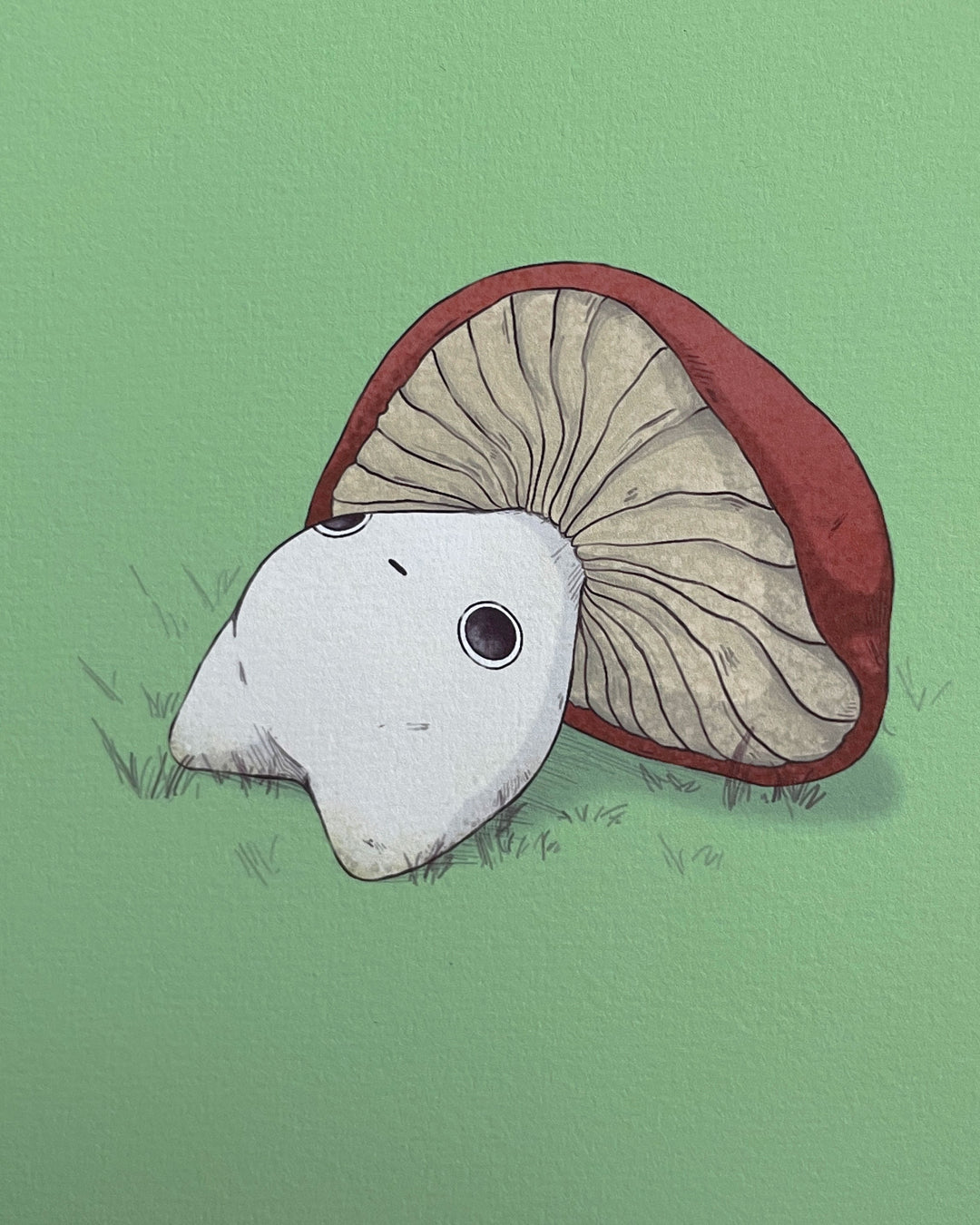 print of a red capped mushling laying down on his back staring upwards closeup