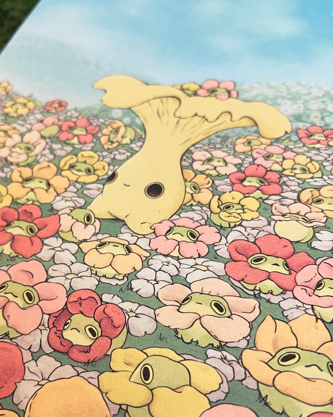 print of chanterelle mushling character surrounded by frogs in flower necklaces closeup