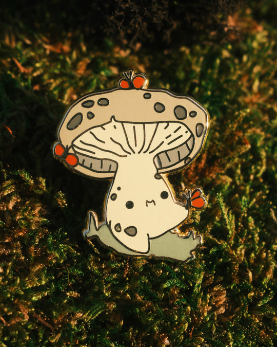 pin of indigo milkcap mushling on a mossy background