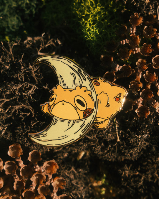 pin of moon toad on a mossy background