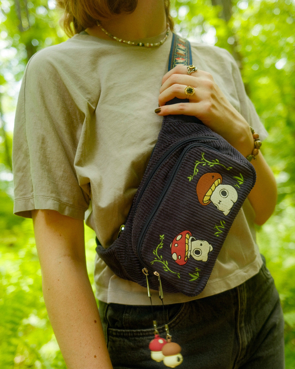 navy fanny pack with two mushroom characters embroidered on the front