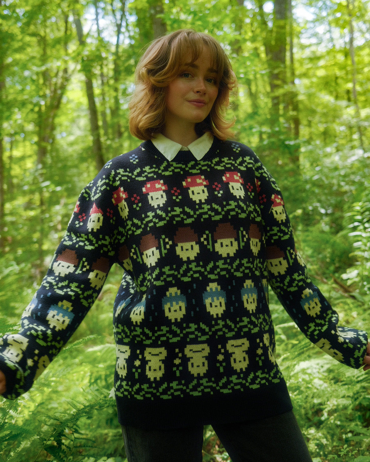 abi toads in a navy mushroom fair isle style sweater in the woods