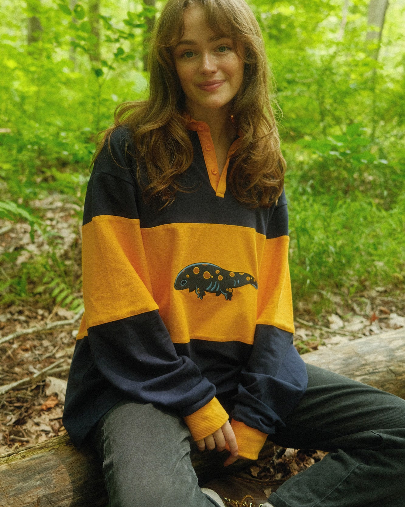 abi toads wearing a navy and gold rugby shirt with a salamander on it