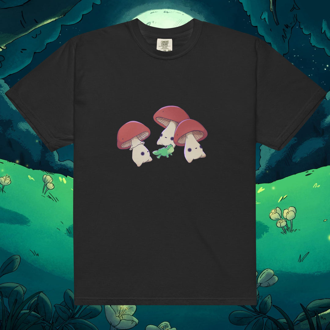 Product mockup of three mushrooms dancing around a frog on a tee shirt