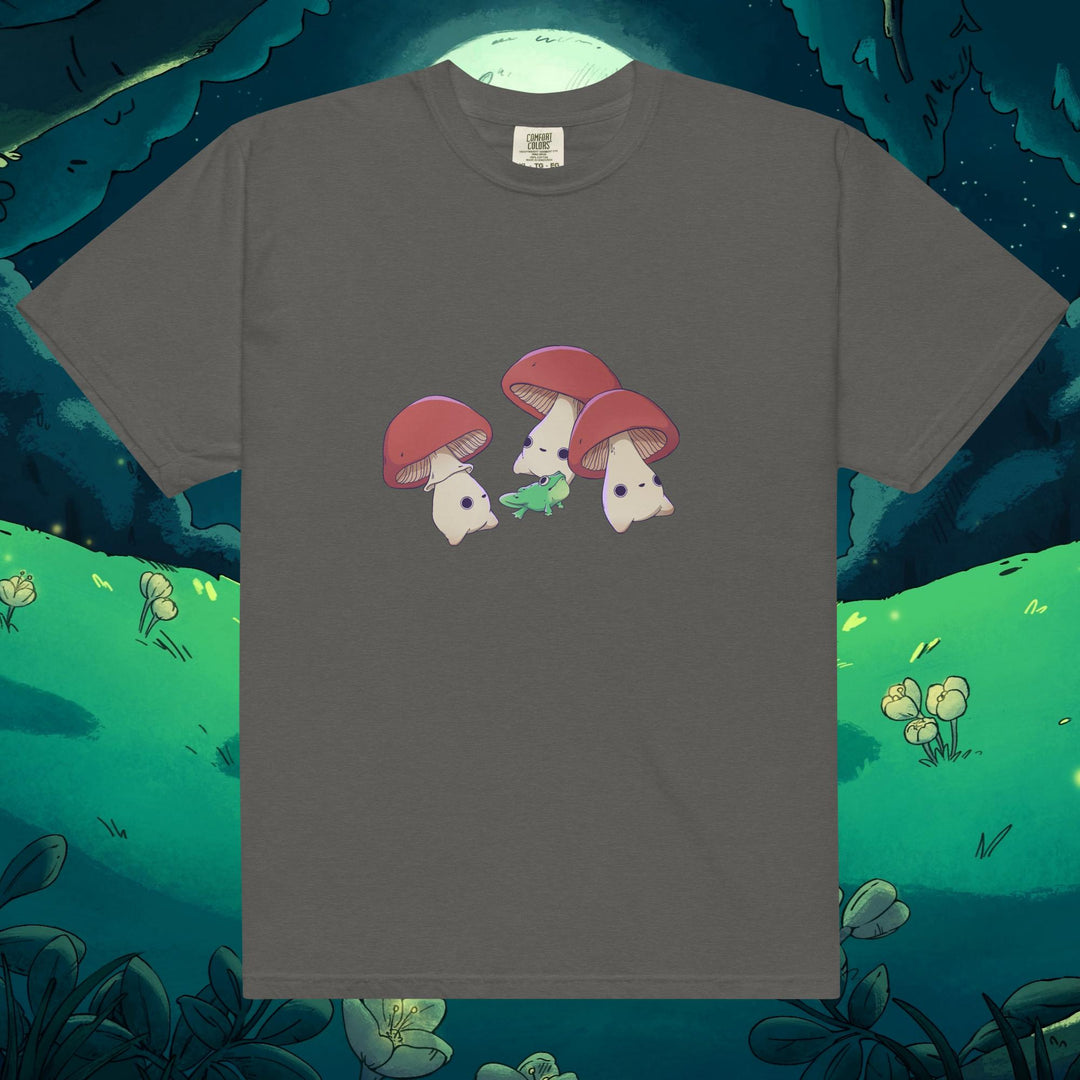 Product mockup of three mushrooms dancing around a frog on a tee shirt